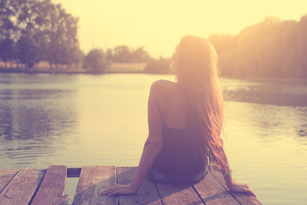Relaxing young woman in nature