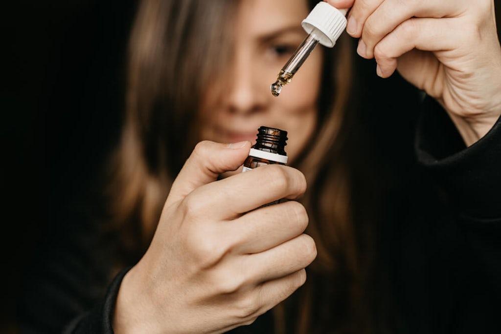A woman about to take CBD oil