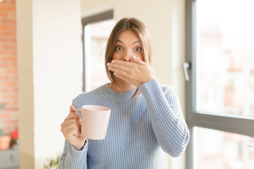 A woman expresses regret after putting too much cannahoney in her tea