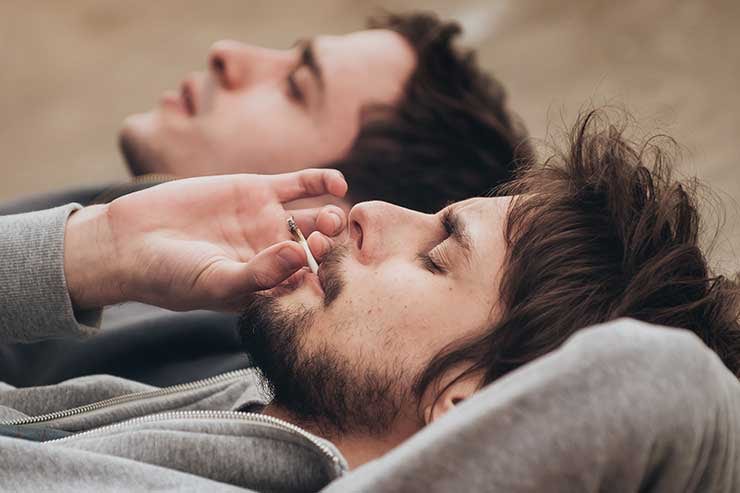 Two men smoking a joint