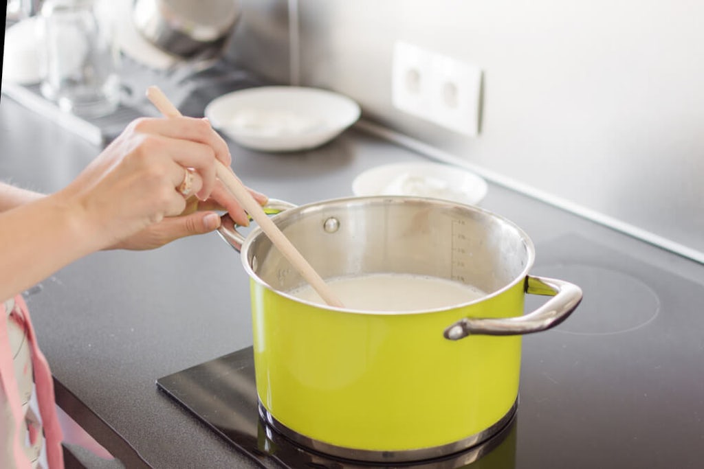 Stirring milk in a pot on the stove