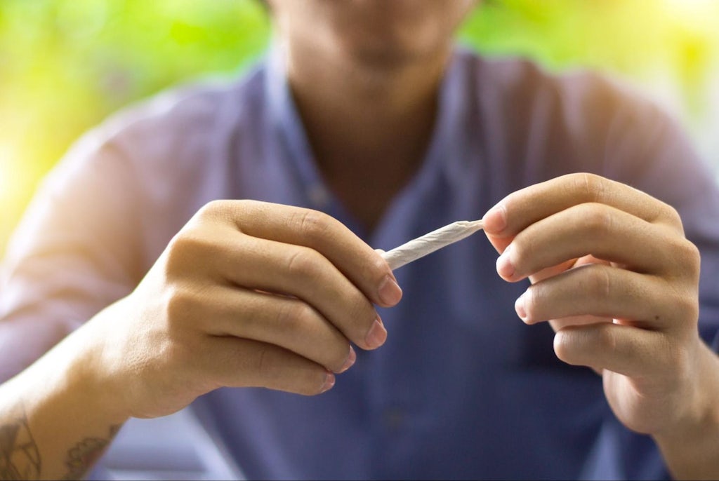 A man rolling a joint
